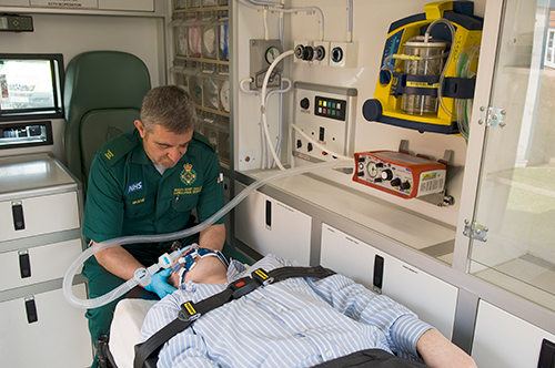Paramedic with patient and ventilator