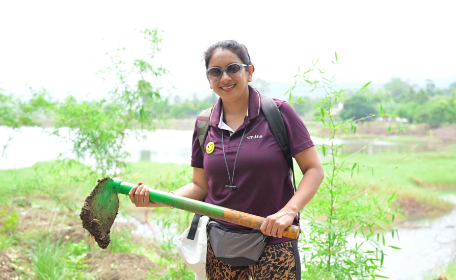 Lady Digging With Spade To Plant Trees